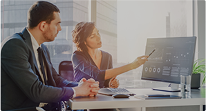 Professionals analyzing data on computer in office setting.