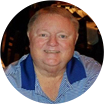 Smiling man in blue and white striped shirt.