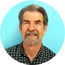 Man smiling against blue background.