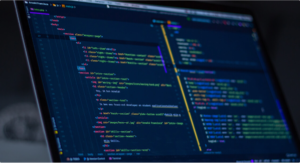 Laptop screen displaying code in development environment.